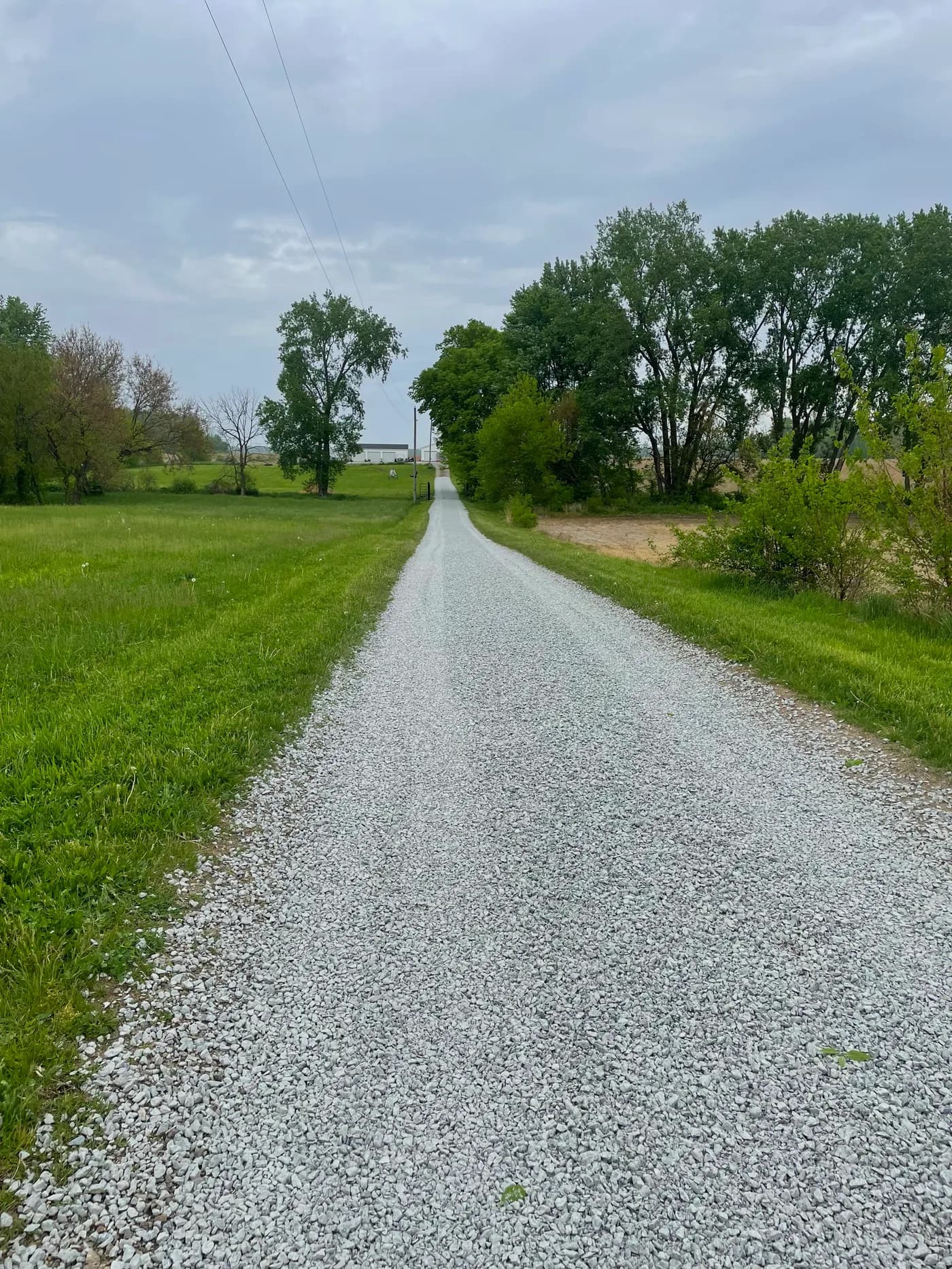Finished gravel lane running through open pasture