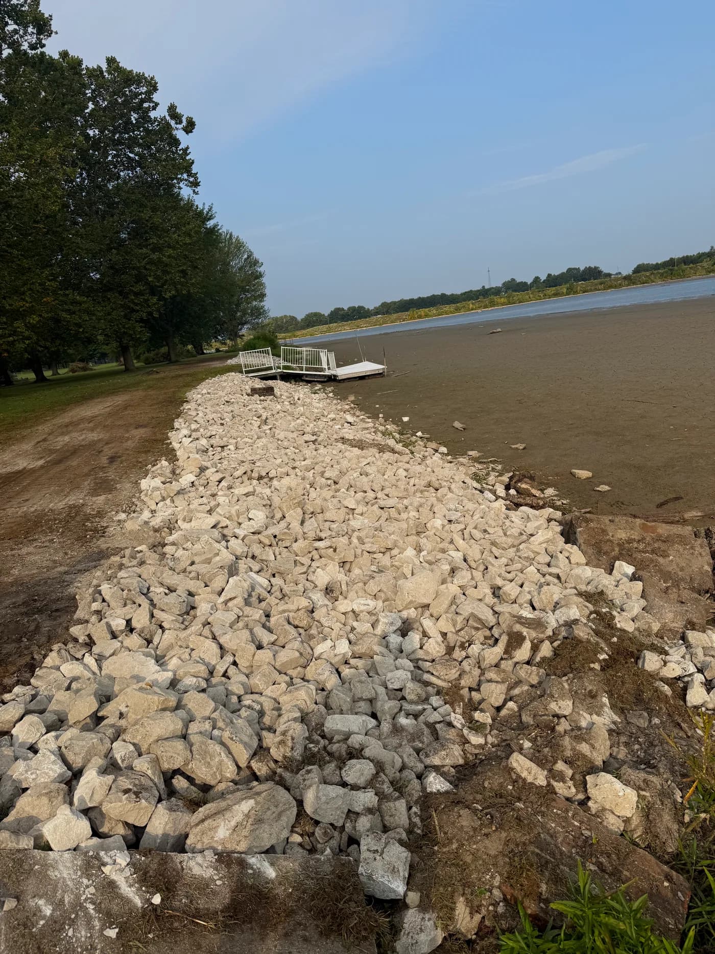 Fresh rip-rap rock laid along the pond bank